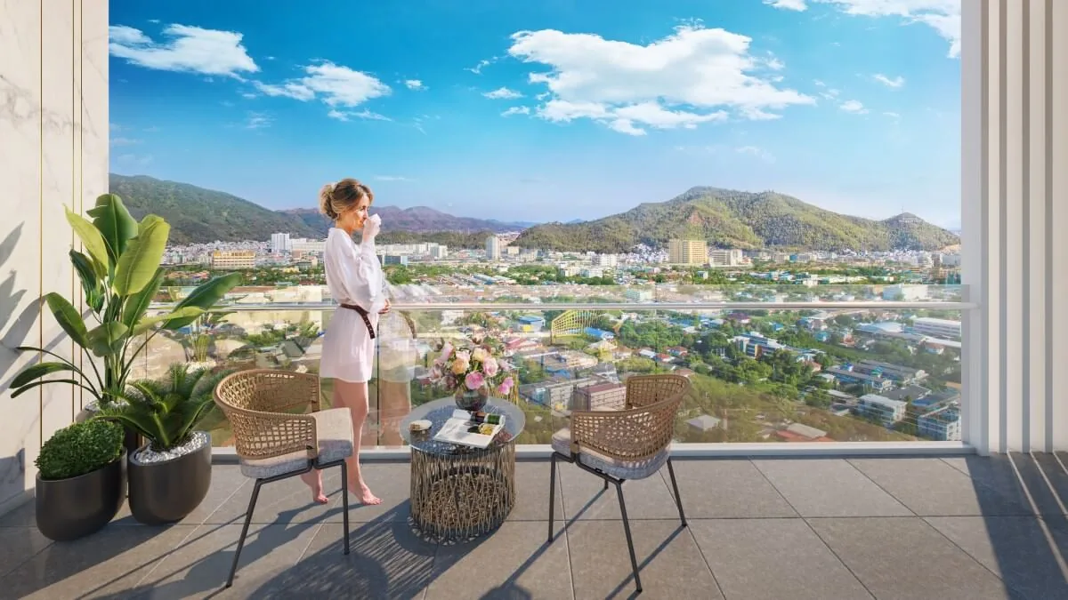 View of the mountains and city from an apartment balcony